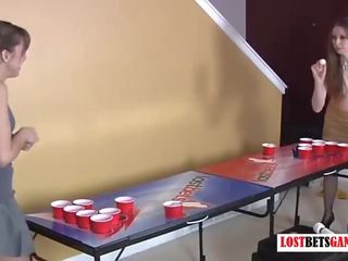 Two attractive girls play strip beer pong